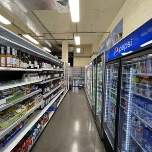 a supermarket aisle with refridgerators