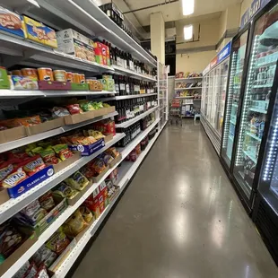 a grocery store aisle with shelves full of food