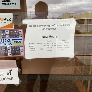a man holding a sign in front of a store