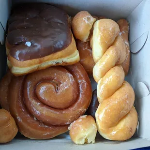 Chocolate Bear Claw, Glaze Twist, Cinnamon Roll, and Donut Holes.