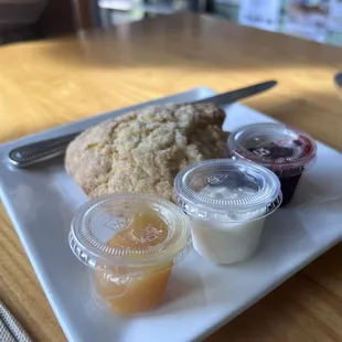 scone with lemon curd, cream, and raspberry jam