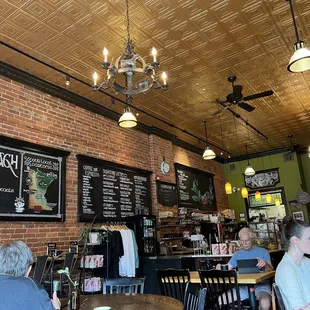 people sitting at tables in a coffee shop