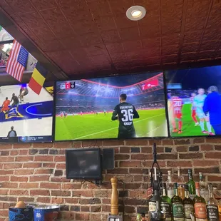 two televisions displaying a soccer game