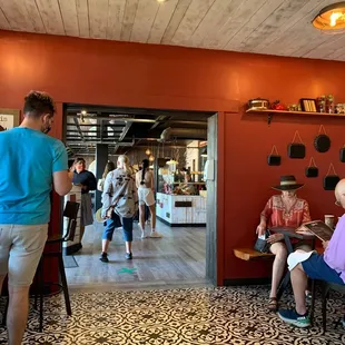people sitting at tables in a restaurant