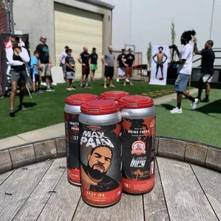 three cans of beer on a barrel