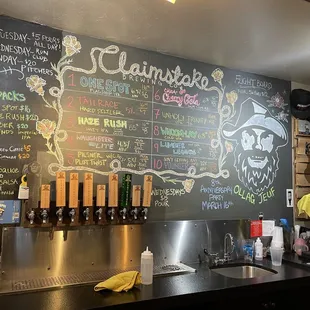 a chalkboard with a variety of beers