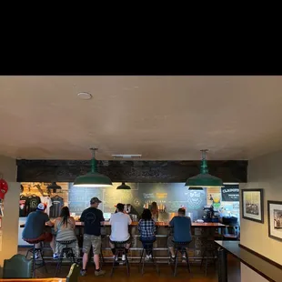 a group of people sitting at a bar
