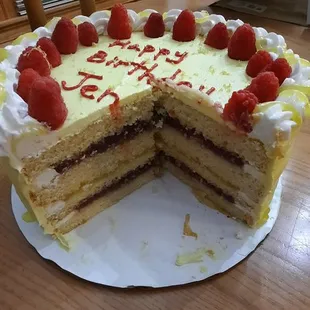 Lemon cake , 2 layers of seedless raspberry,   one lemon and fresh raspberries on top!