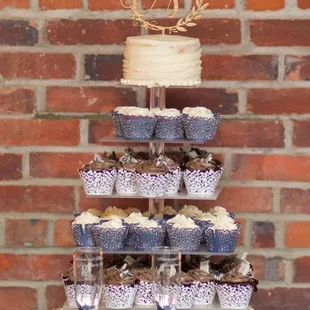a wedding cake and cupcakes