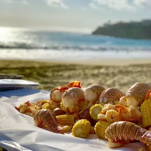 Beautiful presentation of Clambake OC's seafood bake on the beach.