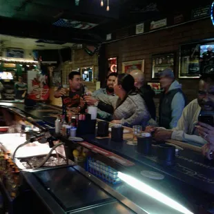a group of people sitting at a bar