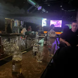 a man sitting at a bar looking at his cell phone