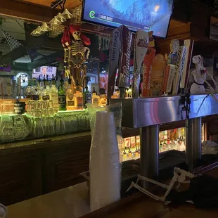 a bar with a skeleton on the counter