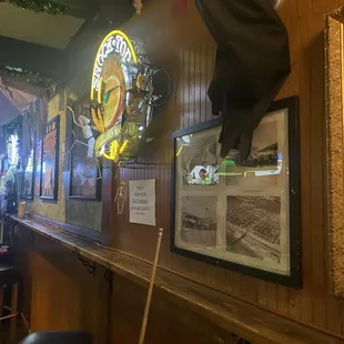 the interior of a bar with a large clock on the wall