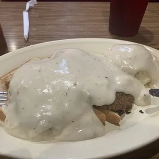 Chicken fried steak over bread and mashed potatoes