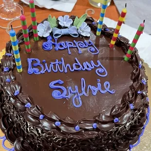 a chocolate birthday cake with candles