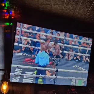 a boxing match on a large screen