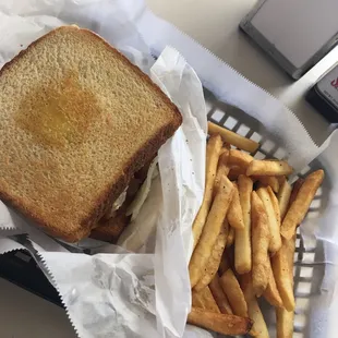 a sandwich and french fries in a basket