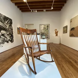 CLMA gallery during the Claremont Collects exhibition featuring a rocking chair by Sam Maloof.