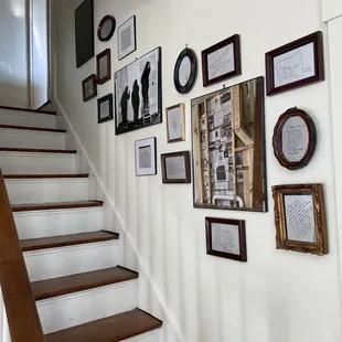 staircase with picture frames on wall