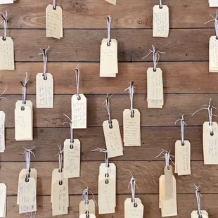 a wooden wall with tags attached to it
