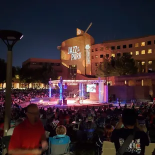 a large crowd of people sitting in lawn chairs