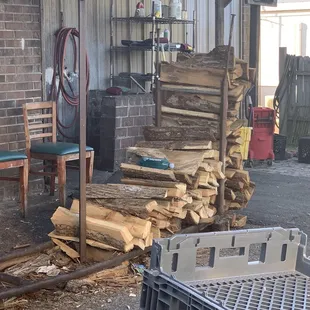 a pile of wood in front of a building