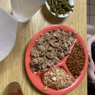 Barbecue plate with coleslaw, baked beans and green beans.