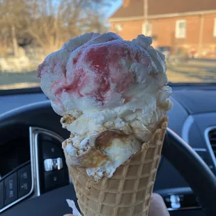 Strawberry cheesecake and Tennessee toffee in a waffle cone. 2 scoops is a medium.