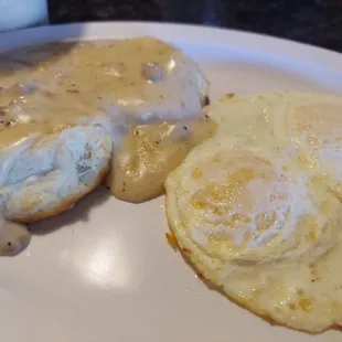 two eggs and gravy on a plate