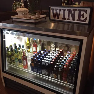 a display of wine bottles in a cooler