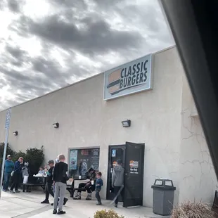 people standing outside of a restaurant