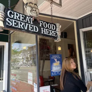 a woman standing in front of a restaurant