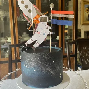 They nailed the galaxy icing with the addition of little pearls. Toppers added by me.