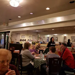 people sitting at tables in a restaurant