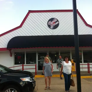 two women walking in front of a classic diner