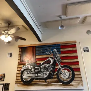 a painting of a motorcycle on the wall