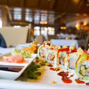 a plate of sushi and sauces