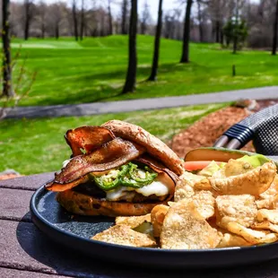a burger and chips on a plate