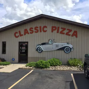 a classic car in front of a restaurant
