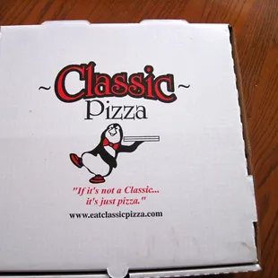 a penguin holding a pizza box