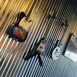 guitars hanging on a wall