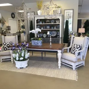 Beautiful blue and white porcelain pieces showcased in our whitewash hutch with deconstructive chairs.