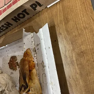 a half eaten pizza in a pizza box