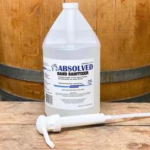 a bottle of alcohol with a wooden barrel in the background