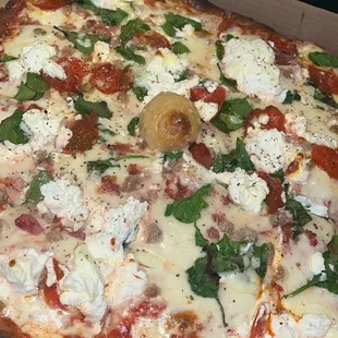 Meat lovers pizza with spinach and ricotta