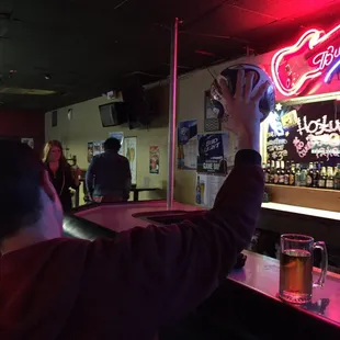 a man taking a picture of a bar