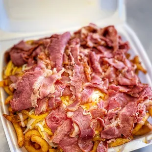 a tray of fries with bacon and cheese