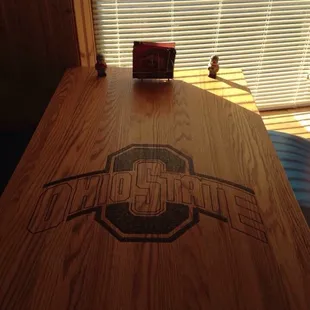 a wooden table with a logo on it