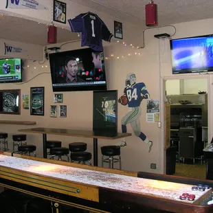 Shuffleboard area with 75&quot; and two 50&quot; TVs and back stand up